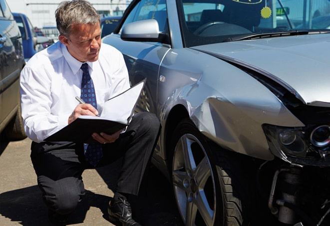 an insurance agent reviewing car coverage options with a customer